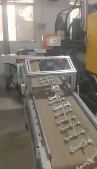 Metal castings on a die-casting production conveyor