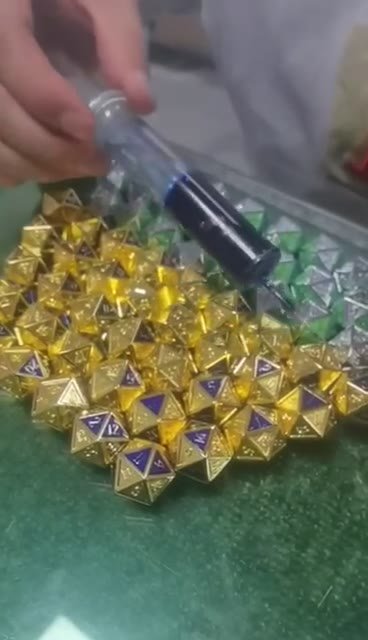 Color being applied to metal dice faces