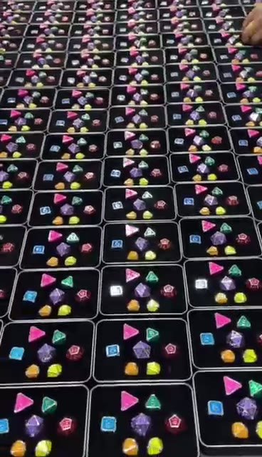 Polyhedral dice sets arranged in individual packaging boxes