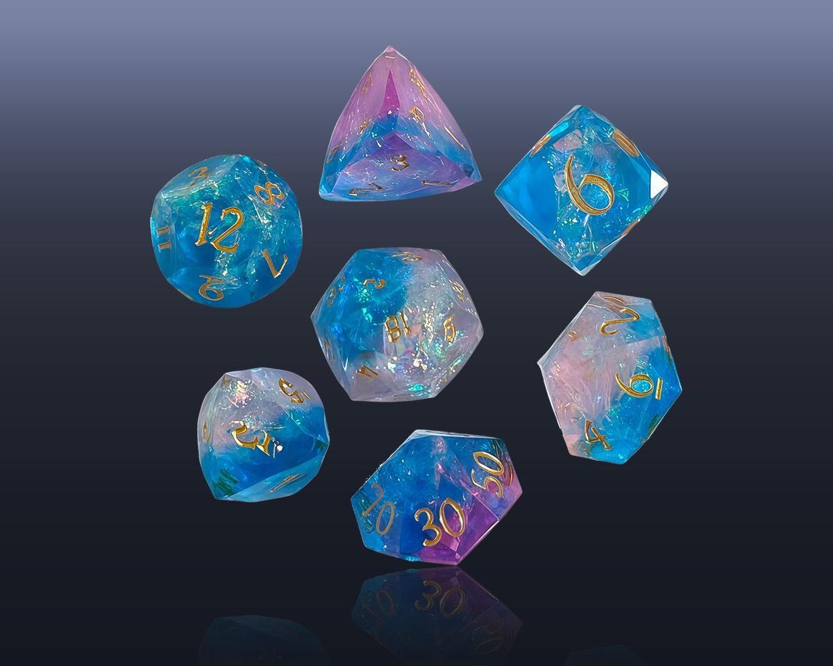 Blue and pink faceted dice with gold numerals on a dark background