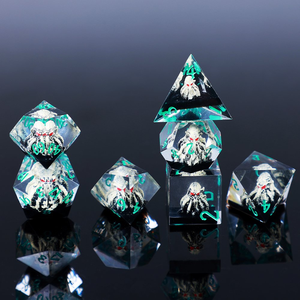 QYJ clear resin RPG dice with sculpted creature inclusions and turquoise numbers